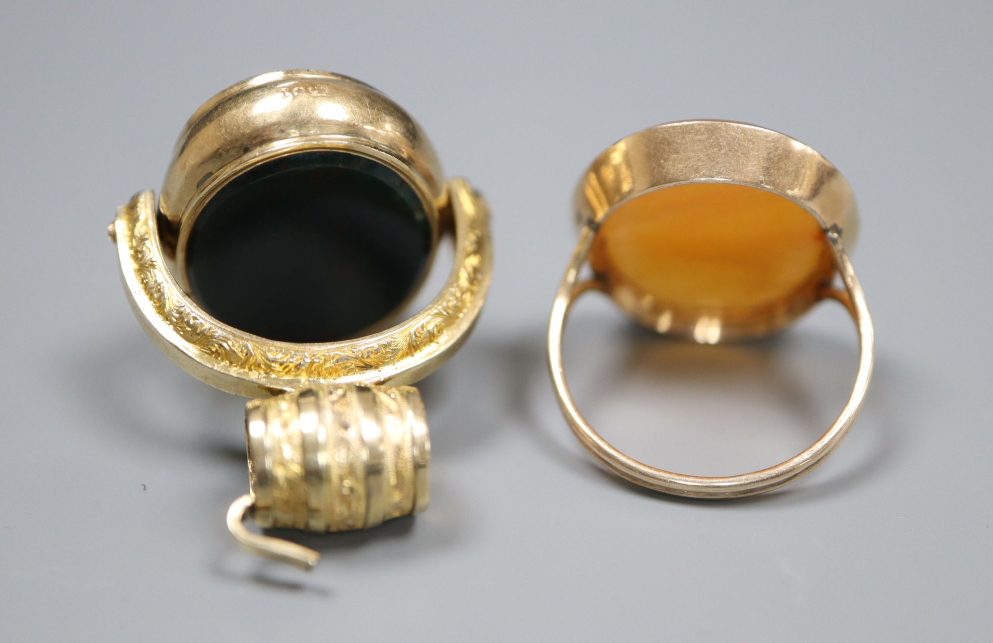 A Victorian 10ct and carnelian swivelling fob, 38mm and a similar yellow metal and carnelian ring